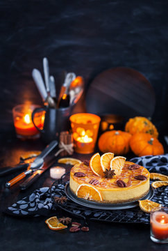 Delicious pumpkin and orange cheesecake decorated with caramel sauce and pecan