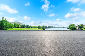 Asphalt highway and green forest natural scenery under the blue sky