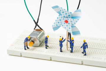 Sustainable energy, alternative clean eco power concept, miniature people worker help building...