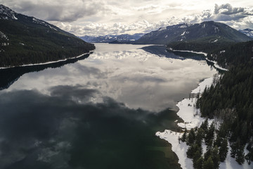 Scenic Pacific Northwest Mountain Lake Aerial Over Snowy Shore