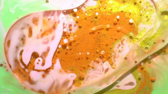 Hippies colors. A real beautiful substance flows. Motion mixed colorful ink