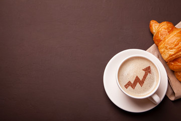 Cup of coffee with arrow up graph  on foam. Increased risks of growth in coffee consumption