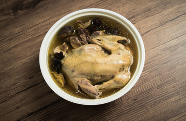 chicken soup with wooden background