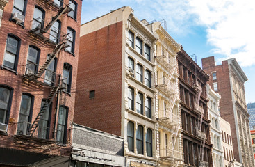 Naklejka premium Block of historic buildings on Broadway in Soho New York City