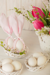 Happy easter. Decor of Easter eggs in small white baskets.