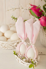 Happy easter. Decor of Easter eggs in small white baskets.