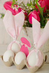 Fototapeta na wymiar Happy easter. Decor of Easter eggs - napkins in the form of ears of Easter rabbits.
