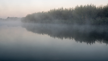 Obraz na płótnie Canvas an misty morning at the water