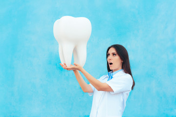 Female Dentist in White Coat with Big Molar Tooth Model