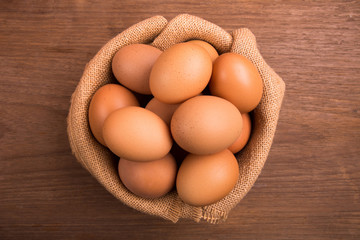 Fresh farm eggs on a wooden rustic background, Whipping eggs and whisk,top view with copy space