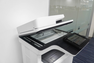 standing multifunctional printer in office for employee to print, scan and copy business documents