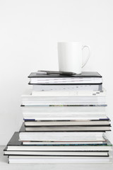 Cup of coffee on stack of books