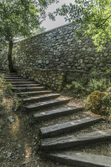 Wooden stairs at the stone wall