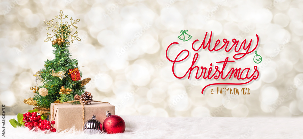 Poster red merry christmas and happy new year handwriting with xmas tree and gift box at blur bokeh light b