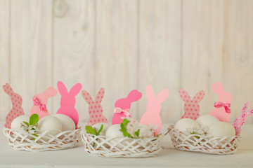 Happy easter. Decor of Easter eggs in small white baskets.