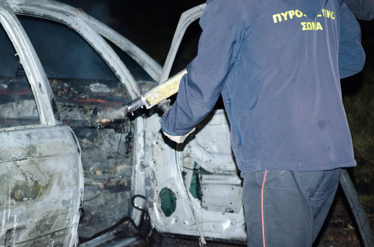 Thieves burn a job car after robbery, firemen put out the fire Athens Greece City Menidi