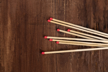 A handful of matches on a dark rustic background with copy space