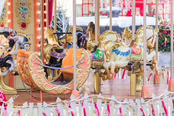 Colourful carnival Horses on a merry-go-round carousel in the amusement park