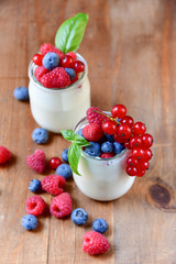 Healthy  yogurt with berry and mint on the wooden table, selective focus