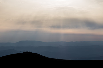 View of Serrasanta hermitage (Umbria, Italy) on top of a mountain, with various others mountains layers in the background