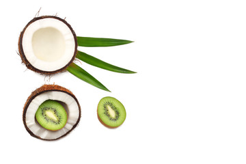 Coconut with kiwi and green leaves isolated on white background. top view with copy space