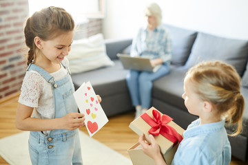 Little girls showing each other what they prepared for their mom birthday