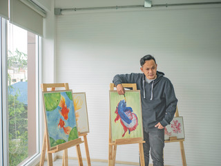 Handsome Young Asian man or water color artist Teaching how to paint in studio