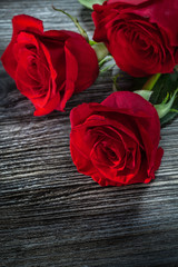 Bunch of aromatic red roses on wooden board