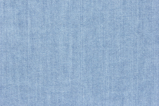 Old blue denim jeans texture or background with visible fibers 