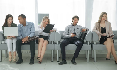 business team studying the working documents sitting in the lobby of the office.