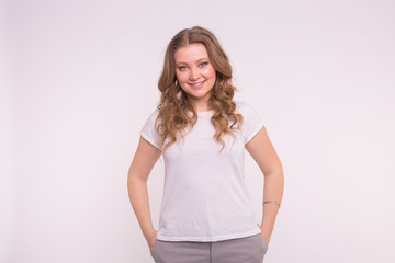 Fashion, style and people concept - pretty young woman dressed in white shirt over white background