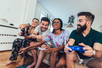 Group of friends play video games together.