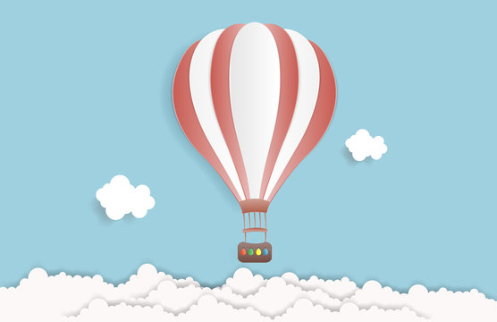 Hot air balloon in the sky with clouds. Origami paper art and digital craft style. Vector illustration