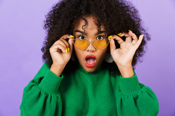 Shocked pretty african woman isolated over violet background wearing glasses. - Powered by Adobe