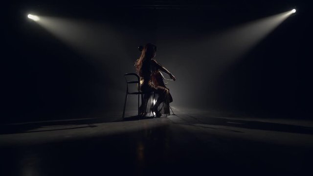 The cellist performs on stage.