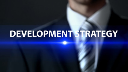 Development strategy businessman in suit standing in front of screen action plan