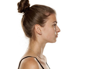 Profile of young serious woman on white background