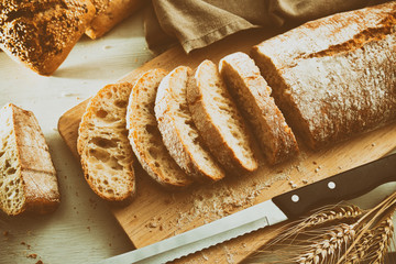 Whole loaf of bread on cutting board traditional vintage