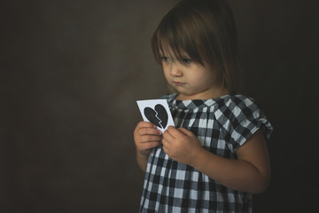 Sad kid with broken heart on dark, frustration