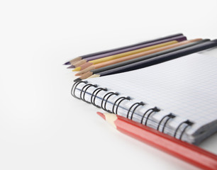 close up.Notepad and pencils on white background .photo with cop