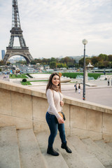 Attractive young lady stand in centre of paris. Background of eiffel tower. Travel