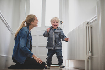 Mother with excited child ready to leave house