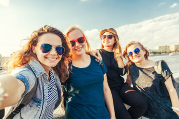 Group of happy smiling carefree young stylish girl female friends on city background, millennials...