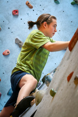 Teenage Boy Training On Climbing Wall