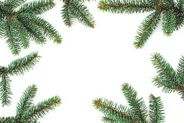 Christmas composition. Green fir, spruce tree branches border isolated on white table backhround. Flat lay, top view, empty space.