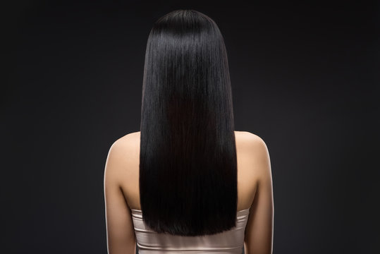 Back View Of Woman With Beautiful Shiny Hair Isolated On Black