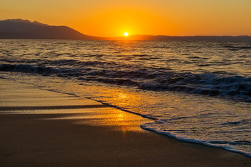 Naklejka premium Early morning , dramatic sunrise over sea and mountain. Photographed in Asprovalta, Greece.