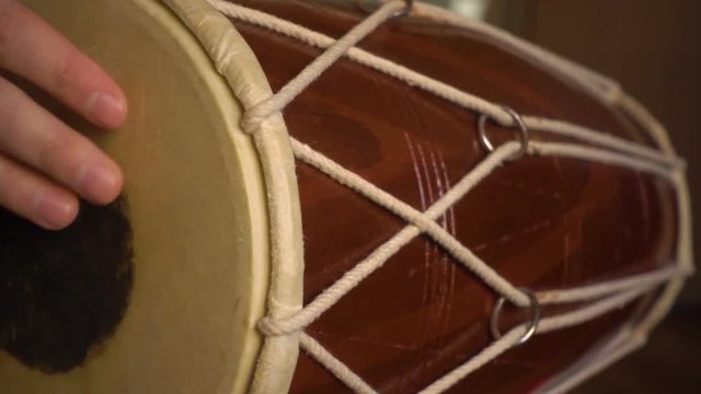 Close up of hands of a man playing a drum. Slow Motion.