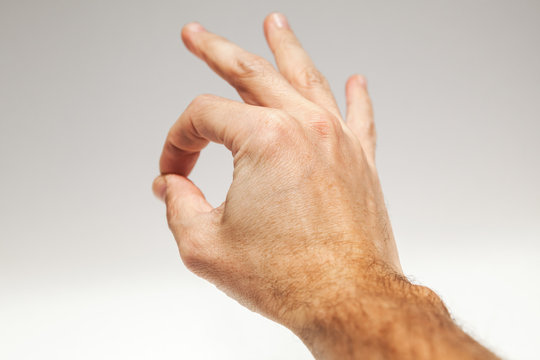 Male hand showing Ok acceptance gesture