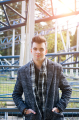 Fototapeta premium Portrait of a young beautiful man in an autumn coat